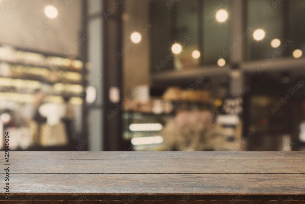 Wood table top and blurred restaurant interior background with vintage filter - can used for display or montage your products. Wood table top and blurred restaurant interior background with vintage filter - can used for display or montage your products.
