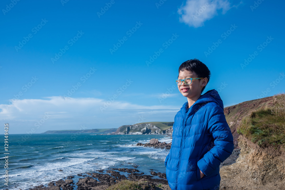 Young asian boy wearing jacket and smiling outdoor Young asian boy wearing jacket and smiling outdoor