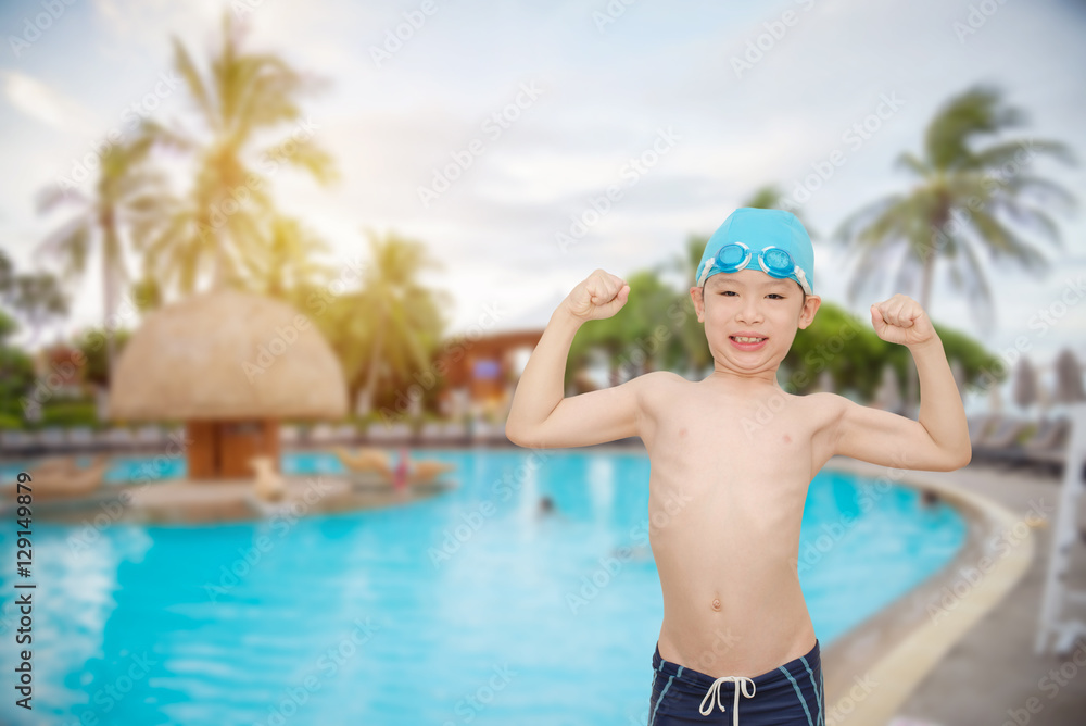 Young asian boy smiling at swiming pool
