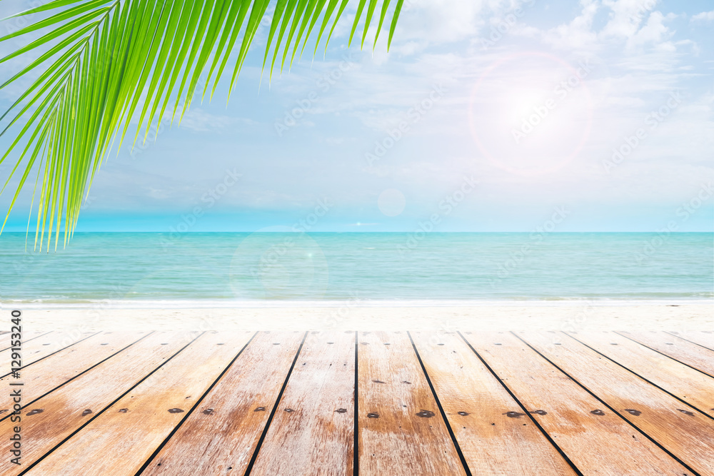 old wood table top on blurred beach background with coconut leaf. Concept Summer, Beach, Sea, Relax.