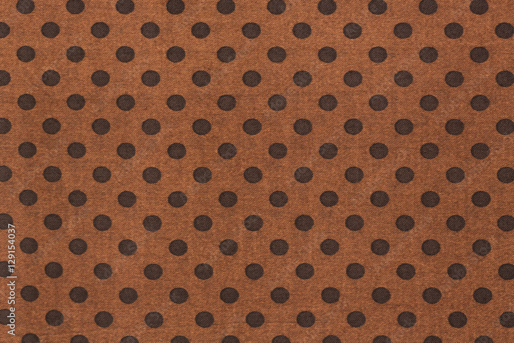 Pattern with big black polka dots on a brown use a background.