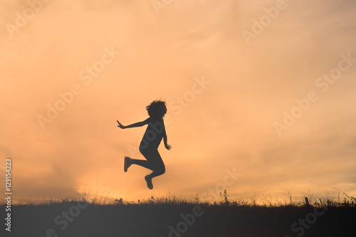 Wallpaper Mural Happy woman jumping against beautiful sunset Torontodigital.ca