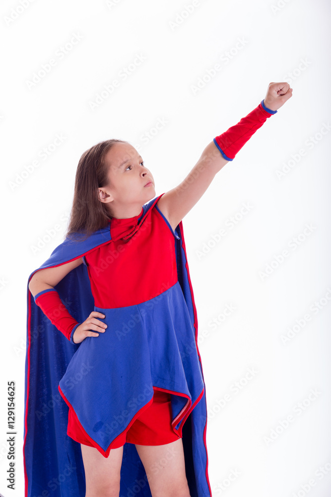 Girl in superhero costume holding arm up Girl in superhero costume holding arm up