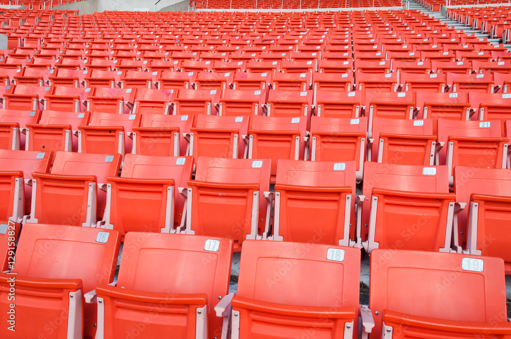 Obraz premium Empty orange seats at stadium,Rows of seat on a soccer stadium