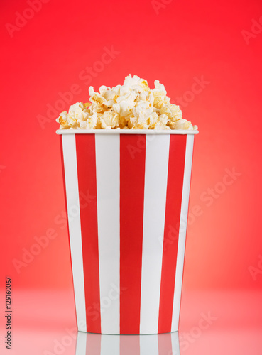 Large striped popcorn box on a bright red