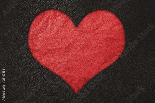 Red heart, red crumpled leather and black leather texture background
