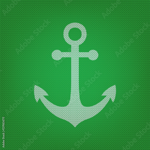 Alarm clock sign. white icon on the green knitwear or woolen clo