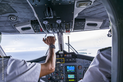 Interior details of a water plane with pilot and co pilot on board while flying. The photography is a demonstration of team work.