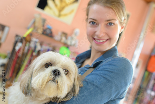 happy woman and dog in grooming salon