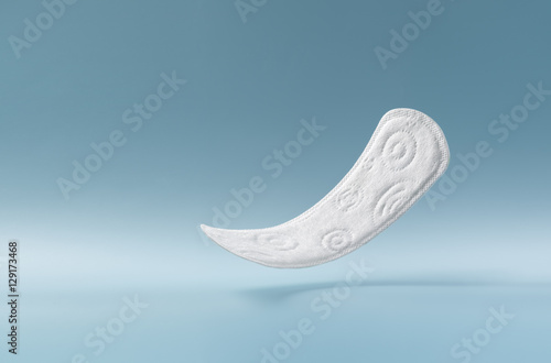 close up view of woman's sanitary pad on color back photo