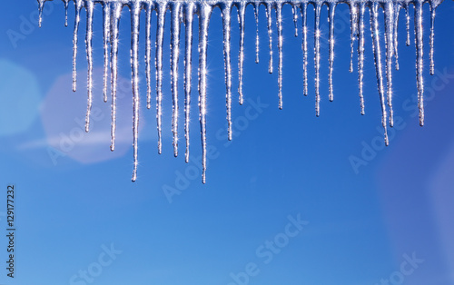 Icicles against the background of the blue sky