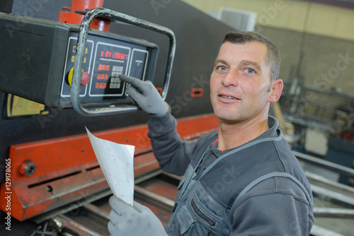 technicien using a electronic device in factory