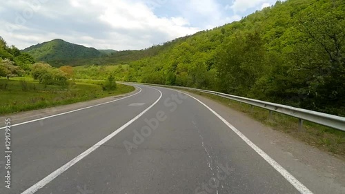 Driving on the highway in the mountains. Point of view camera filming.