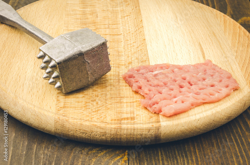 raw chop on a cutting wooden board/raw chop and steel hammer on a cutting board