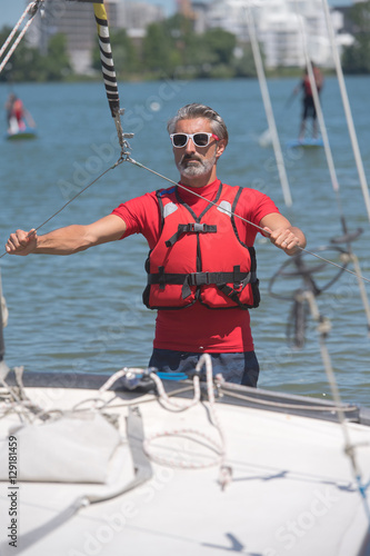 portrait of mature sportsman near catamaran © auremar