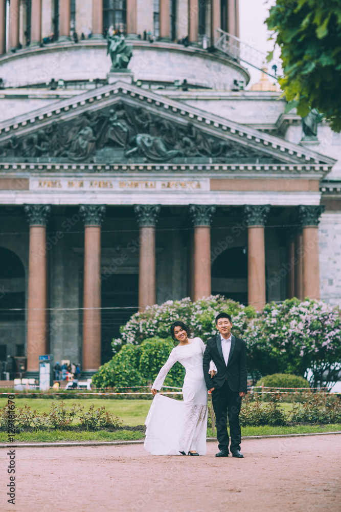 Bride and groom on the background of St. Isaac's Cathedral