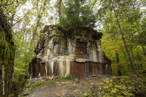 Wolf's Lair,  Adolf Hitler's Bunker in Poland. First Eastern Front military headquarters in World War II. Complex was blown up and abandoned on 1945. Autumn, chaparral grown ruins, trees, leaves. photo