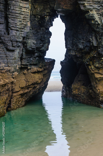 Natural arch in the rock of the cliffs in Ribadeo