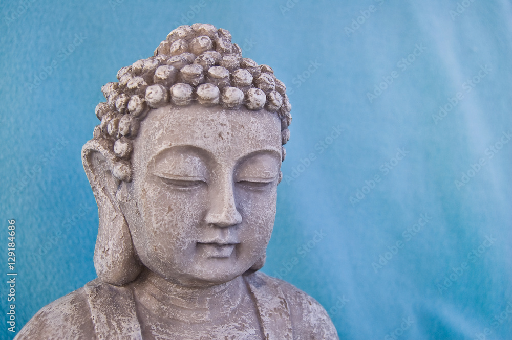 Buddha face on blue background.