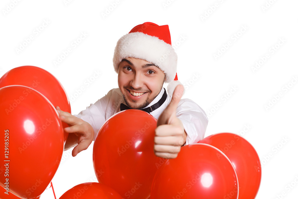 young man in a Christmas hat in studio on white, with a gift, young man in a Christmas hat in studio on white, with a gift,