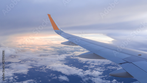 Wing of airplane fly over the blue sky and white cloud 4