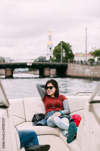 Bride and groom are floating on a boat on the city's rivers and canals © cmirnovalexander