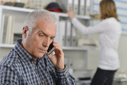 Senior office worker taking an important call