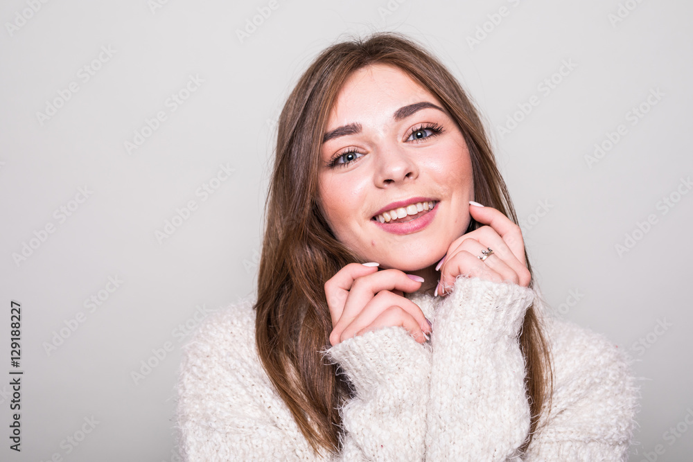 Pretty model in sweater in studio isolated gray background Pretty model in sweater in studio isolated gray background