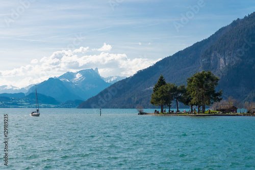 Thunersee lake in Interlaken, Switzerland and Alps range background