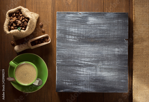 coffee cup and beans on wood