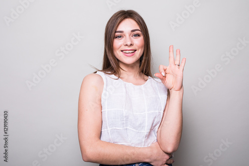 Wallpaper Mural Happy young woman showing ok sign with fingers Torontodigital.ca