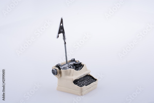 Retro syled tiny typewriter model on white background photo