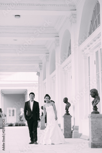 Groom and bride kiss near Wedding palace