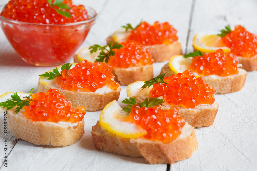 Red caviar on bread with lemon and parsley Red caviar on bread with lemon and parsley