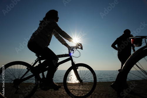 shillouettes of people a strolling at the beach photo