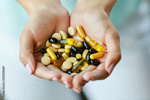 Vitamins And Supplements. Woman Hands Full Of Medication Pills