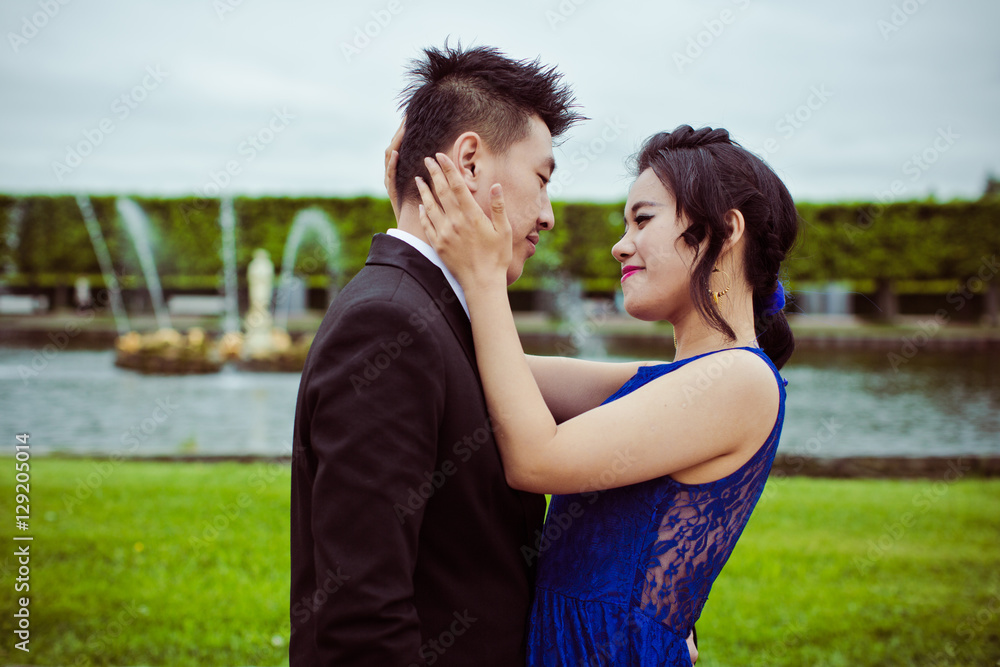 Bride and groom on their wedding day outdoors. Chinese bride in a blue dress