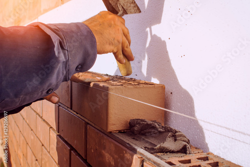 Vászonkép Facing bricklaying construction work, manual labor.