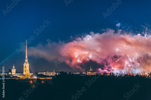 Fireworks over the city of St. Petersburg (Russia) on the feast of "Scarlet Sails", in the rain with fog and smoke. 