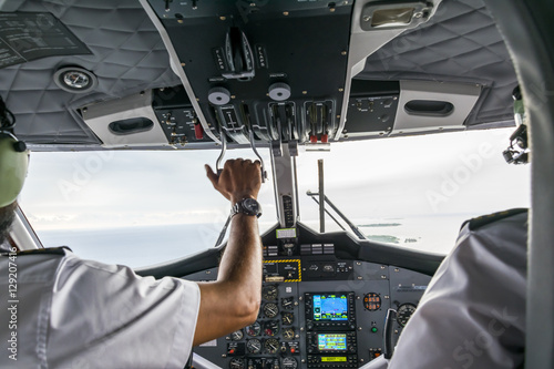 Interior details of a water plane with pilot and co pilot on board while flying. The photography is a demonstration of team work.