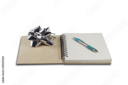 Pen on book on isolated white background