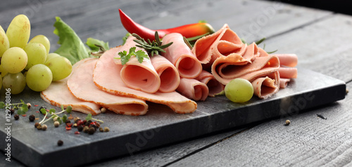 cold meat plate. Sliced ham with lettuce, shallow depth, selective focus