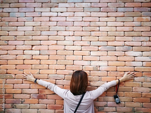 Hug the brick wall. Hipster style on the brick wall.