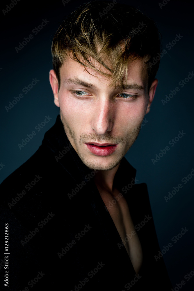 handsome young man in black jacket posing in studio handsome young man in black jacket posing in studio