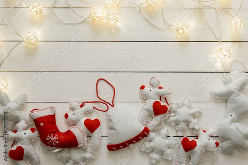 Christmas hand made decoration on the wooden background with lig