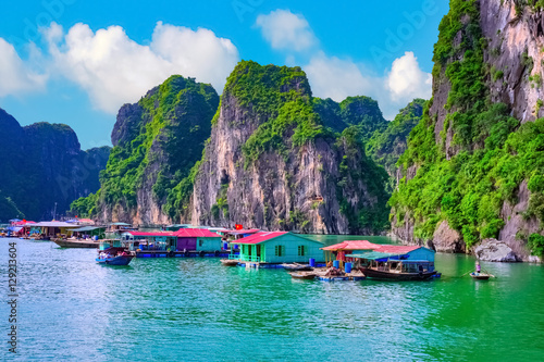 Floating fishing village rock island in Halong Bay Vietnam, Southeast Asia. UNESCO World Heritage Site. Junk boat cruise to Ha Long Bay. Landscape. Popular asian landmark famous destination of Vietnam © 12ee12
