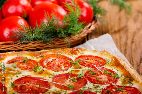 Pie with tomato and fresh herbs, close up