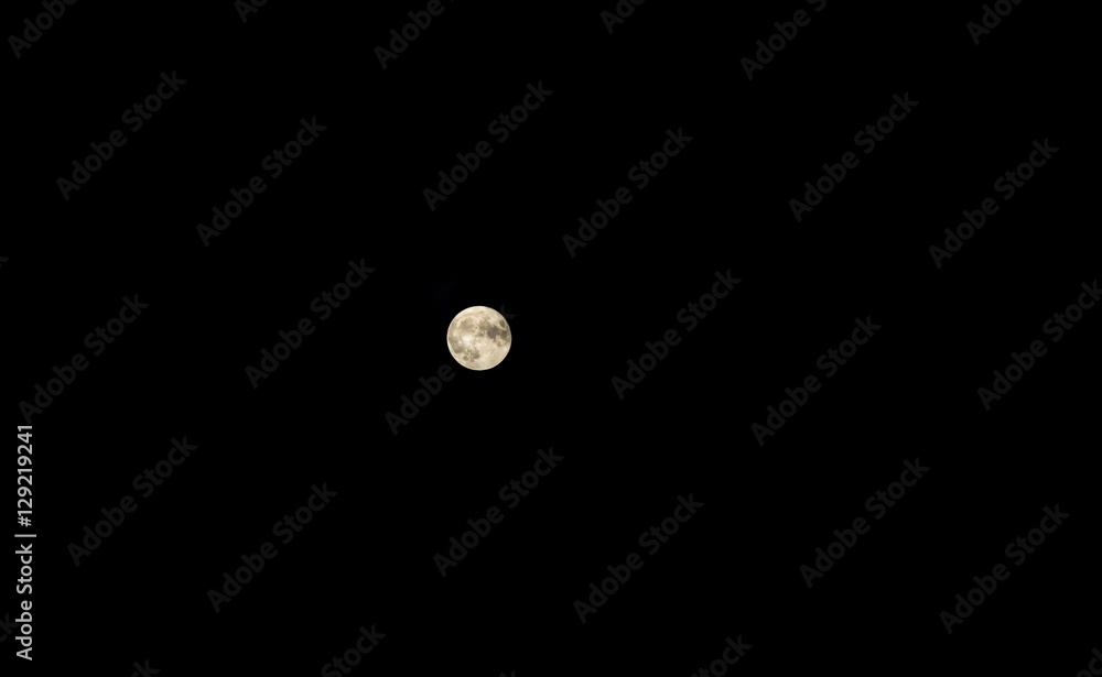 Close up of full moon on dark sky background Close up of full moon on dark sky background