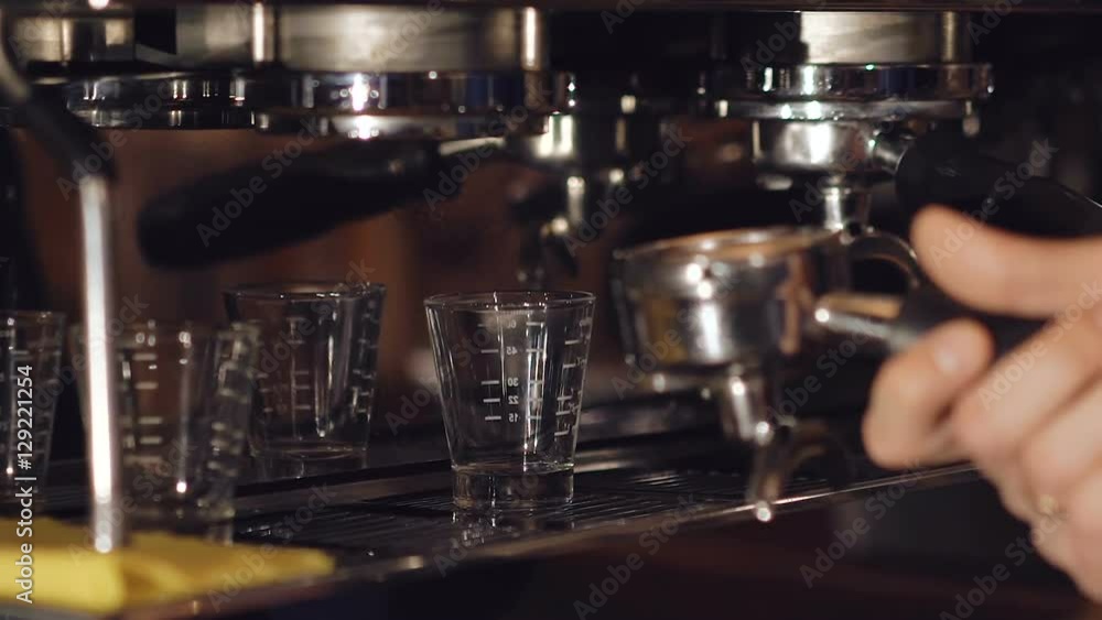 Two cups of espresso being poured from a professional espresso machine Two cups of espresso being poured from a professional espresso machine