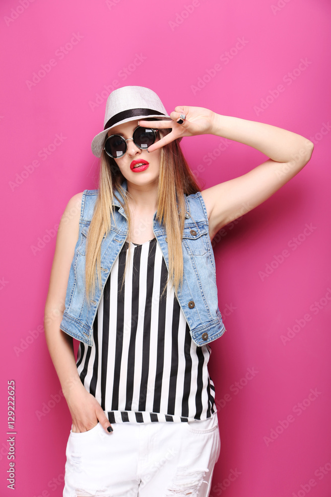 Portrait of a beautiful hipster girl on pink background Portrait of a beautiful hipster girl on pink background